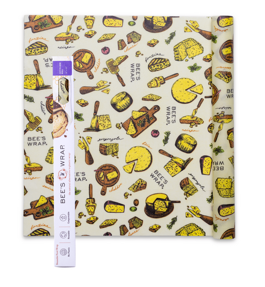 A Bees Wrap Roll with the Wheels n Wedges print pattern with packaging on a white background.